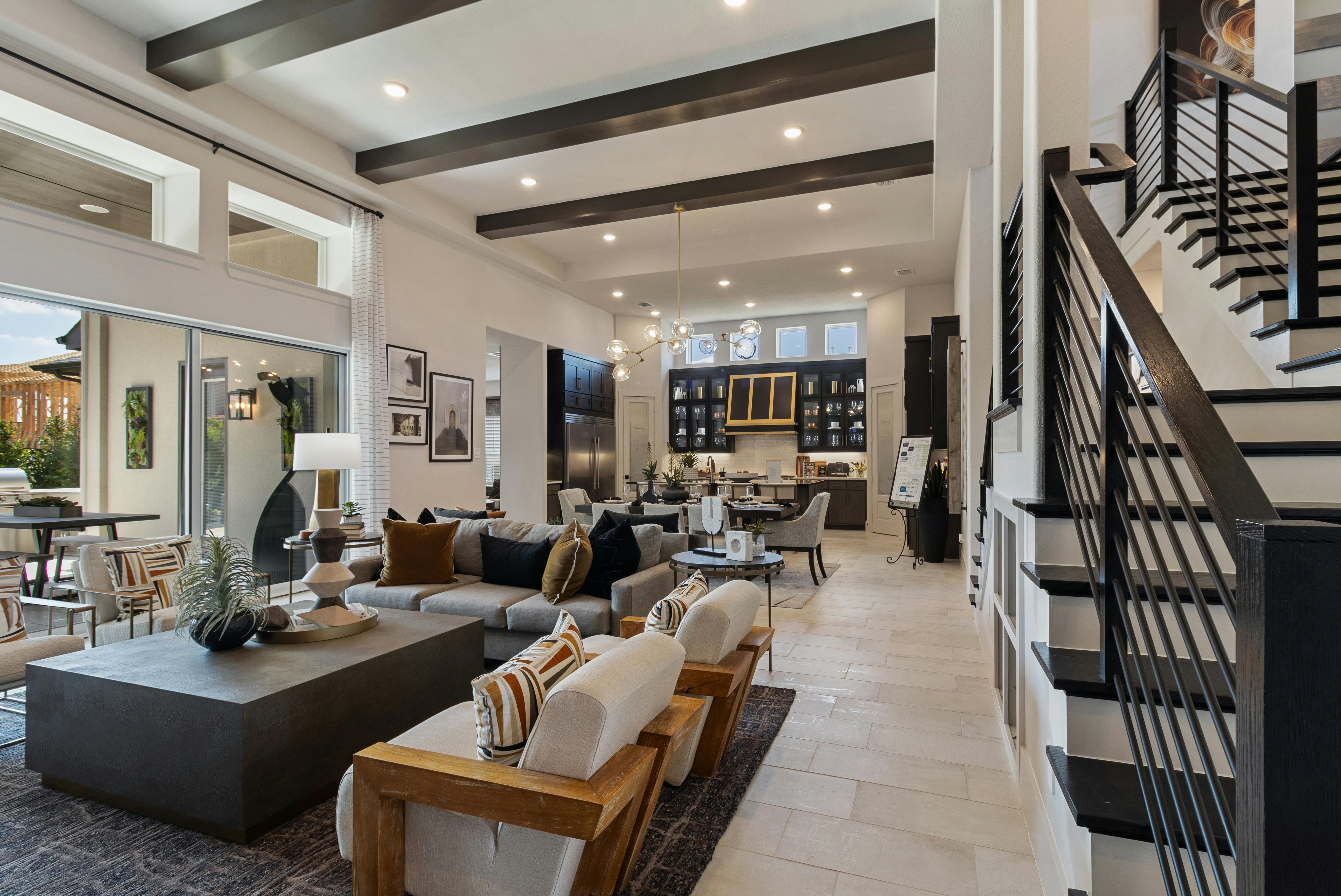 Spacious contemporary living room with stylish furniture and open kitchen area.